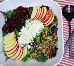 apple spinach salad with cranberries and feta, apple cranberry feta spinach salad in a large white bowl with black salad utensils