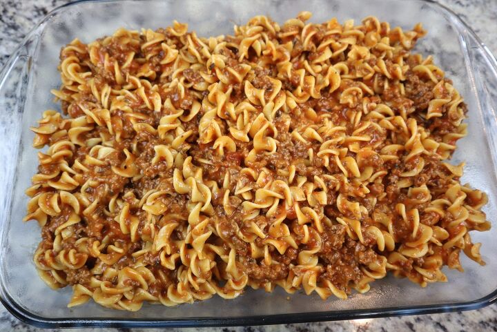easy cheesy beef noodle casserole recipe, meat and noodles spread into a baking dish