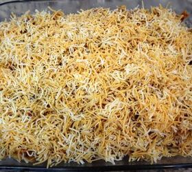 easy cheesy beef noodle casserole recipe, cheese sprinkled on top of noodles