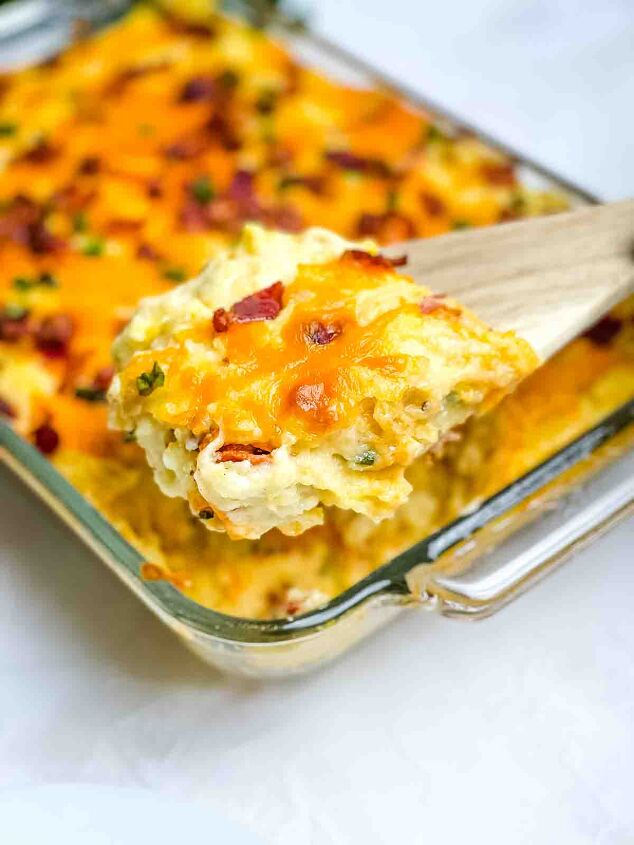 easy twice baked mashed potato recipe, A wooden spoon scooping up some of the potato casserole