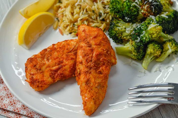 air fryer chicken tenders low carb no breading, Chicken Tenders on white plate with fork lemon wedges orzo and cooked air fryer broccoli