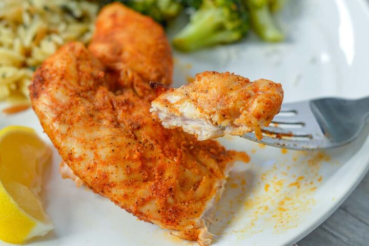 air fryer chicken tenders low carb no breading, Up close look at cut off piece of chicken tender on white plate with broccoli in background