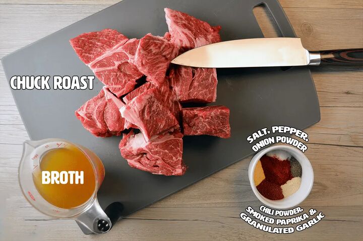 easy instant pot shredded beef multi purpose, Multi purpose Shredded Beef Ingredients on grey cutting board with knife and chuck roast chunks with cup of vegetable broth