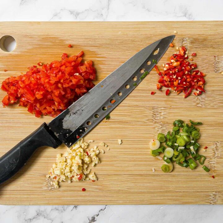 pork belly fried rice, Red pepper chilli garlic spring onion on chopping board with a knife