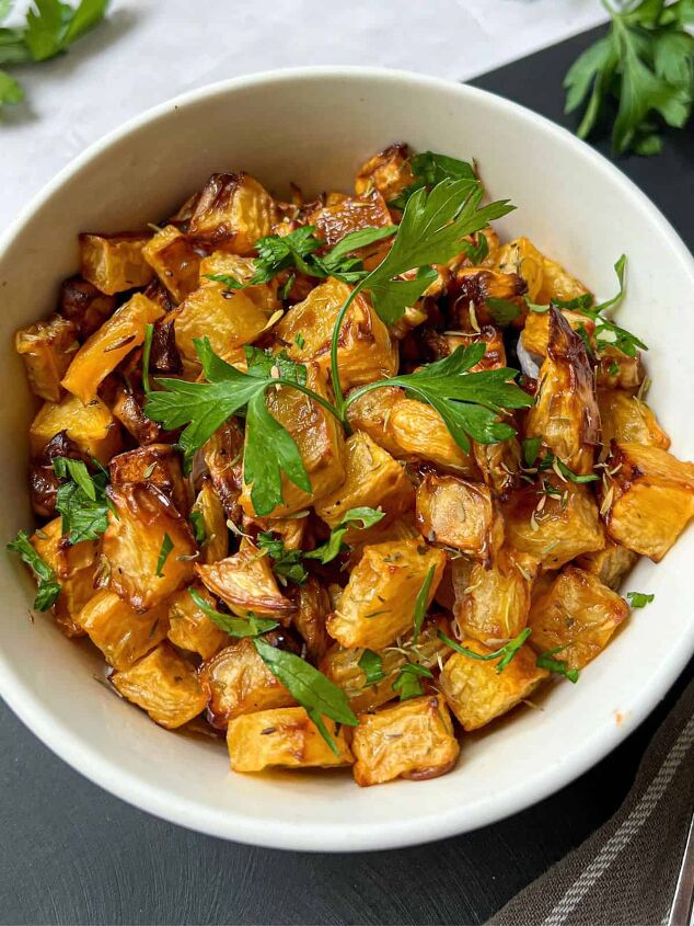 roasted swede oven and air fryer, A bowl of roasted swede cubes garnished with fresh parsley
