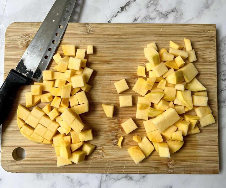 roasted swede oven and air fryer, Cubes of swede on a wooden chopping board There is also a knife on the chopping board