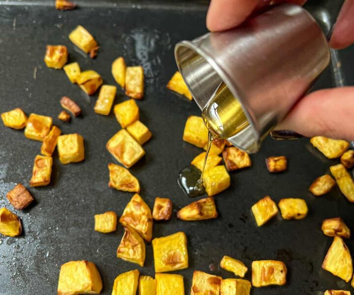 roasted swede oven and air fryer, Honey being poured over roasted cubes of swede