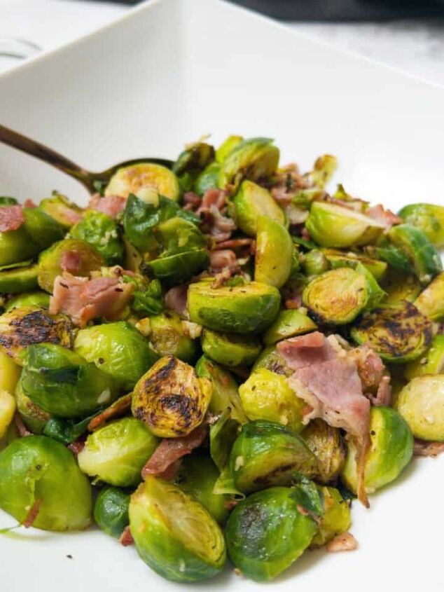 roasted swede oven and air fryer, Brussel sprouts with bacon and garlic in a white bowl