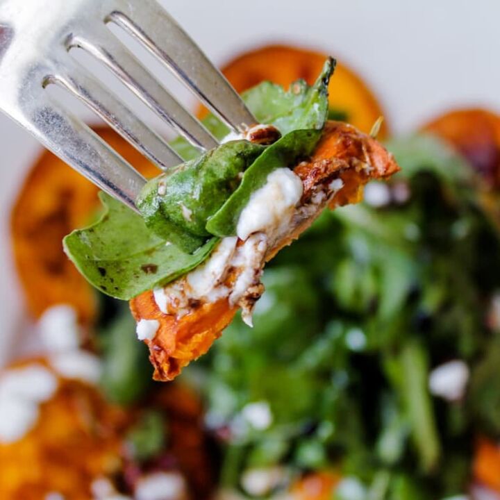 spinach cranberry salad recipe, A forkful of arugula salad with goat cheese and sweet potato