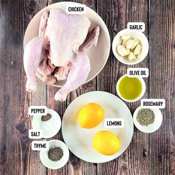 air fryer whole roast chicken with lemon and garlic, Assorted ingredients for air fryer whole chicken recipe neatly arranged on a wooden table including fresh lemons minced garlic olive oil and a selection of dried herbs rosemary and thyme with a whole chicken ready for preparation