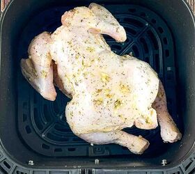 air fryer whole roast chicken with lemon and garlic, The chicken breast side down in the air fryer basket