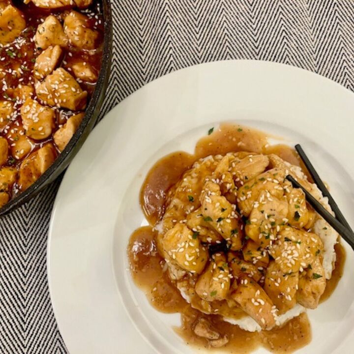 bourbon chicken recipe better than take out bourbon chicken, Overhead image of a plate of Bourbon Chicken with a skillet next to it