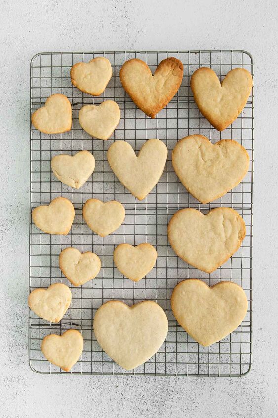 iced shortbread cookies, several heart shaped cookies on a wire rack