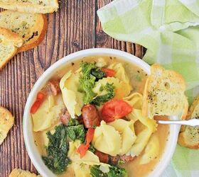 sausage tortellini soup, tortellini soup with bread crisps on wood board with kitchen towel