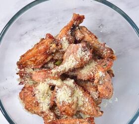 crispy garlic parmesan wings, Chicken wings in bowl with butter and parmesan