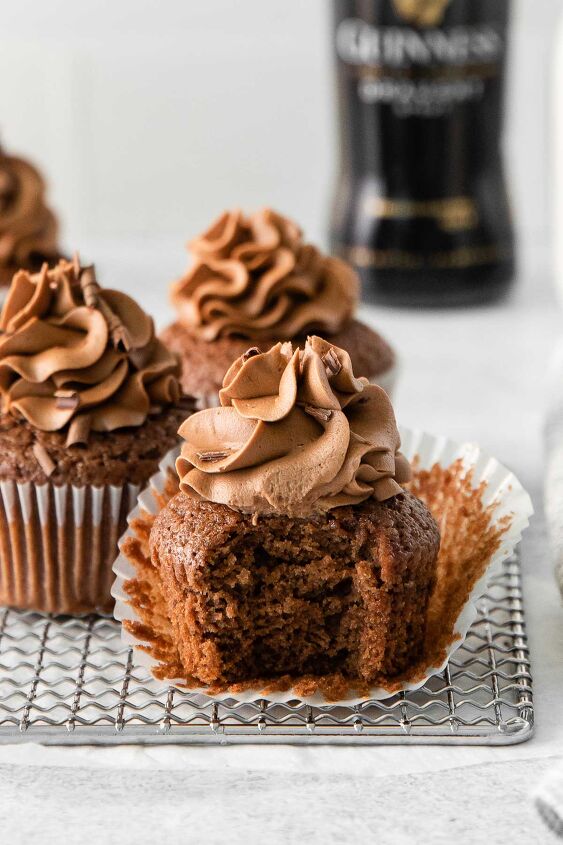 guinness chocolate cupcakes, guinness chocolate cupcake with a bite taken out of it