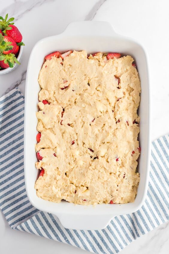 fresh strawberry cobbler, Cobbler dough spooned and spread over the strawberries in a large baking dish from above