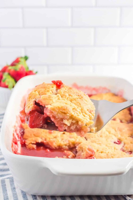 fresh strawberry cobbler, Strawberry cobbler being scooped from a pan from the side