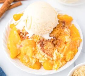fresh strawberry cobbler, Peach dump cake gooey on a plate topped with a scoop of vanilla ice cream from the side on a counter