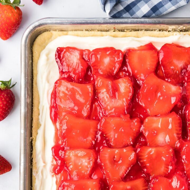 fresh strawberry cobbler, Strawberry pizza with a cookie dough frosting and glazed strawberries from above showing most of a sheet pan on a counter
