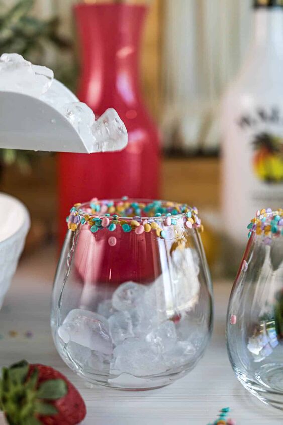 drunk bunny cocktail perfect for a grown up easter, Pouring ice into glasses with sprinkles on rim