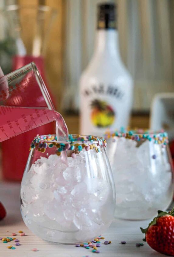 drunk bunny cocktail perfect for a grown up easter, Pouring pink lemonade into glasses of ice with sprinkles on rim