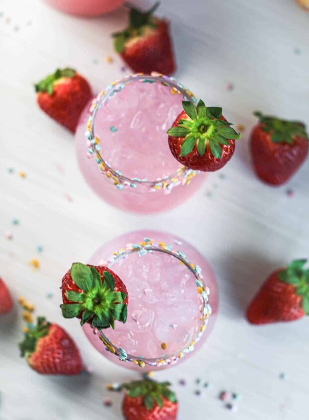 drunk bunny cocktail perfect for a grown up easter, Pink cocktails from above with sprinkles on rim with strawberries and sprinkles on table