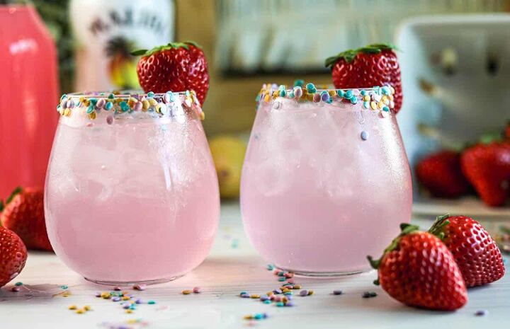 drunk bunny cocktail perfect for a grown up easter, Pink cocktails with sprinkles on rim with strawberries and sprinkles on table