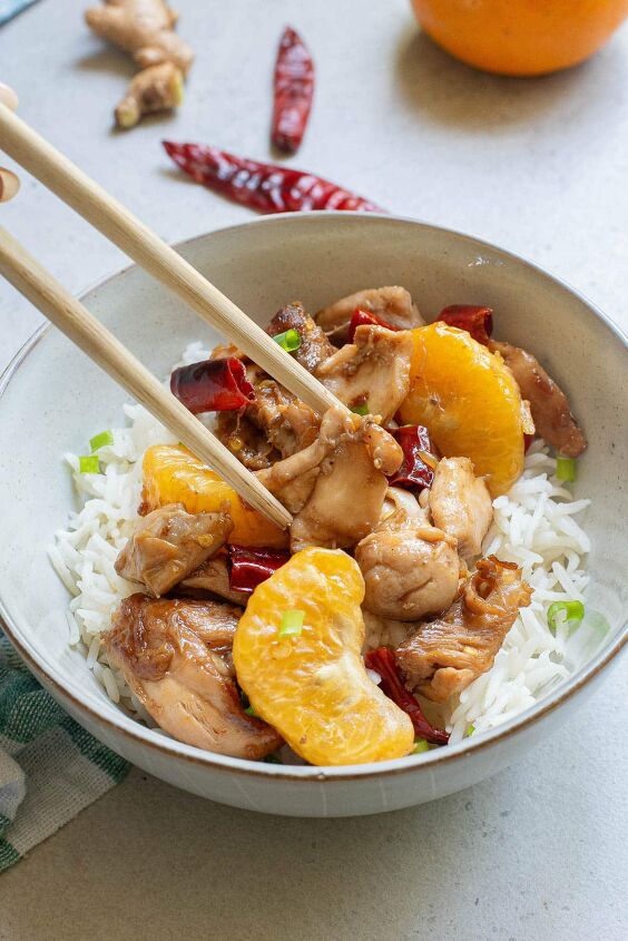 how to make easy chinese mandarin chicken, Mandarin chicken over rice in a white bowl with chopsticks