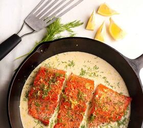 honey mustard salmon, Cast iron skillet with salmon fillets a fish spatula and lemon wedges