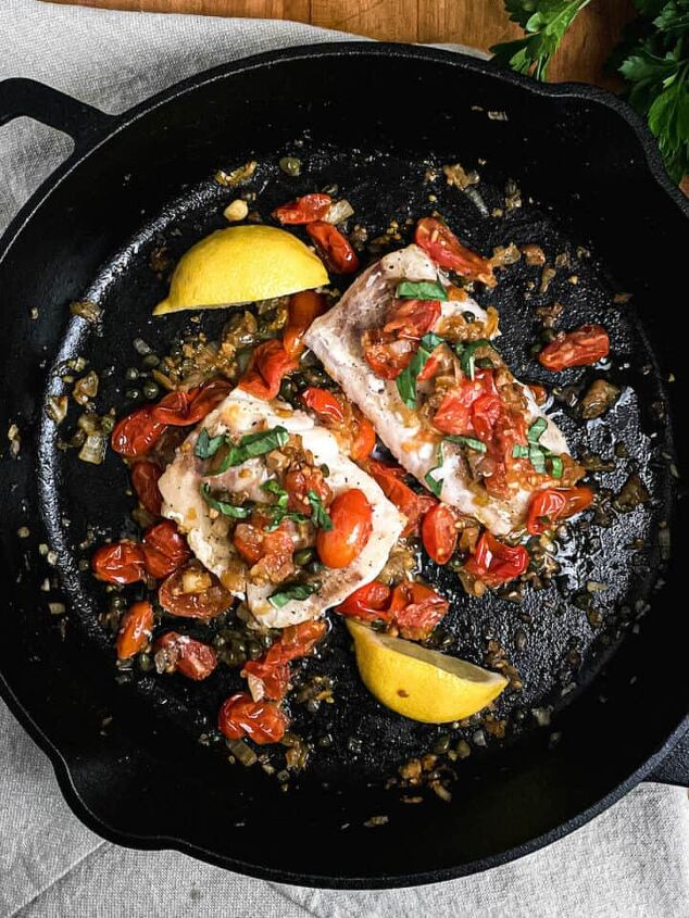 baked mediterranean spot prawns, tuscan cod with capers and tomatoes in a cast iron pan