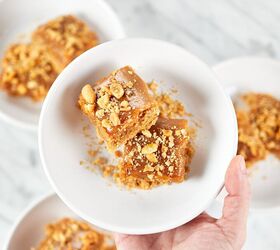 peanut butter brownie blondies, Holding a small plate with slices of keto peanut butter brownies
