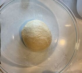 how to make the best brioche hamburger buns from scratch, a ball of dough in a glass bowl