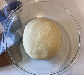 how to make the best brioche hamburger buns from scratch, a ball of dough in a glass bowl