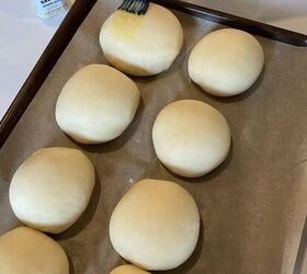 how to make the best brioche hamburger buns from scratch, brushing egg wash onto homemade hamburger buns