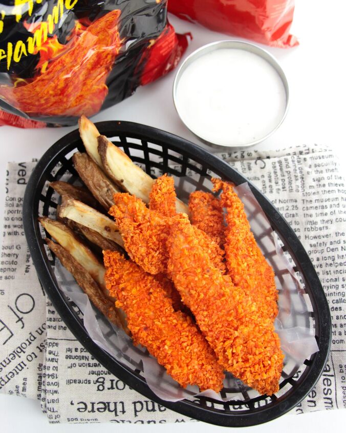 doritos chicken tenders, doritos chicken strips and fries in a basket next to dipping sauce