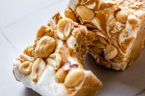 Topped with roasted peanuts for extra crunch and texture, this 4 ingredient fudge is sure to please any peanut butter lover!