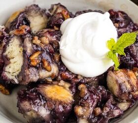 blueberry cobbler bubble up, A plate of blueberry monkey bread topped with a dollop of whipped cream and garnished with a mint leaf