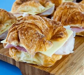 ham and cheese croissant recipe simple croissant sandwich, ham and cheese croissant sandwiches on a wooden cutting board