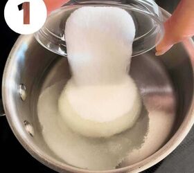 how to make the best iced coffee at home, White sugar being poured into a small saucepan with water
