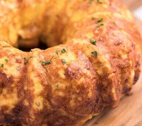 bundt pan hash brown breakfast casserole, angled down shot of egg breakfast casserole that was shaped by a bundt pan served on wooden tray with handle