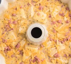 bundt pan hash brown breakfast casserole, egg casserole mixture added to a bundt pan to prepare for cooking ham bits shredded cheese and biscuit chunks