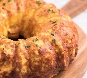 bundt pan hash brown breakfast casserole, breakfast casserole removed from bundt pan and placed on wooden serving board parsley garnish