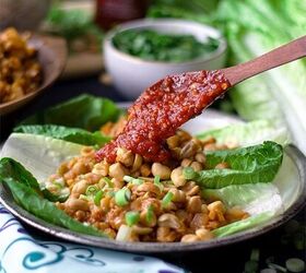 She puts some peanuts on lettuce and then dabs everything in a sauce she can't stop herself from devouring