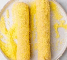 easy lemon shortbread cookies, Two cookie dough logs rolled in yellow sugar on a plate