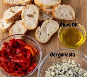 easy gorgonzola crostini with roasted red pepper, A bowl of roasted red peppers some slices of French baguette a little bowl of olive oil and a bowl of crumbled blue cheese on a wooden background