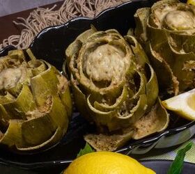 stuffed artichokes made sicilian style, A black tray with three stuffed artichokes and lemons