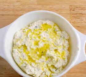 baked ricotta easy italian appetizer, A casserole dish with mixed ricotta and cheese with olive oil drizzled over it