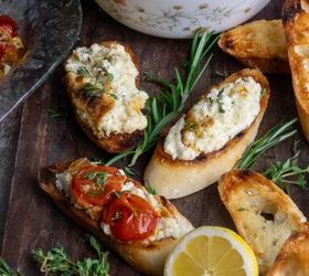 baked ricotta easy italian appetizer, Crostini with cheese spread on them and tomatoes on a board with lemons and herbs