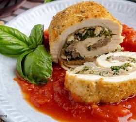 amazing chicken rollatini with spinach and sausage stuffing, A breaded chicken roll stuffed with sausage and spinach on a plate with marinara sauce and a sprig of basil